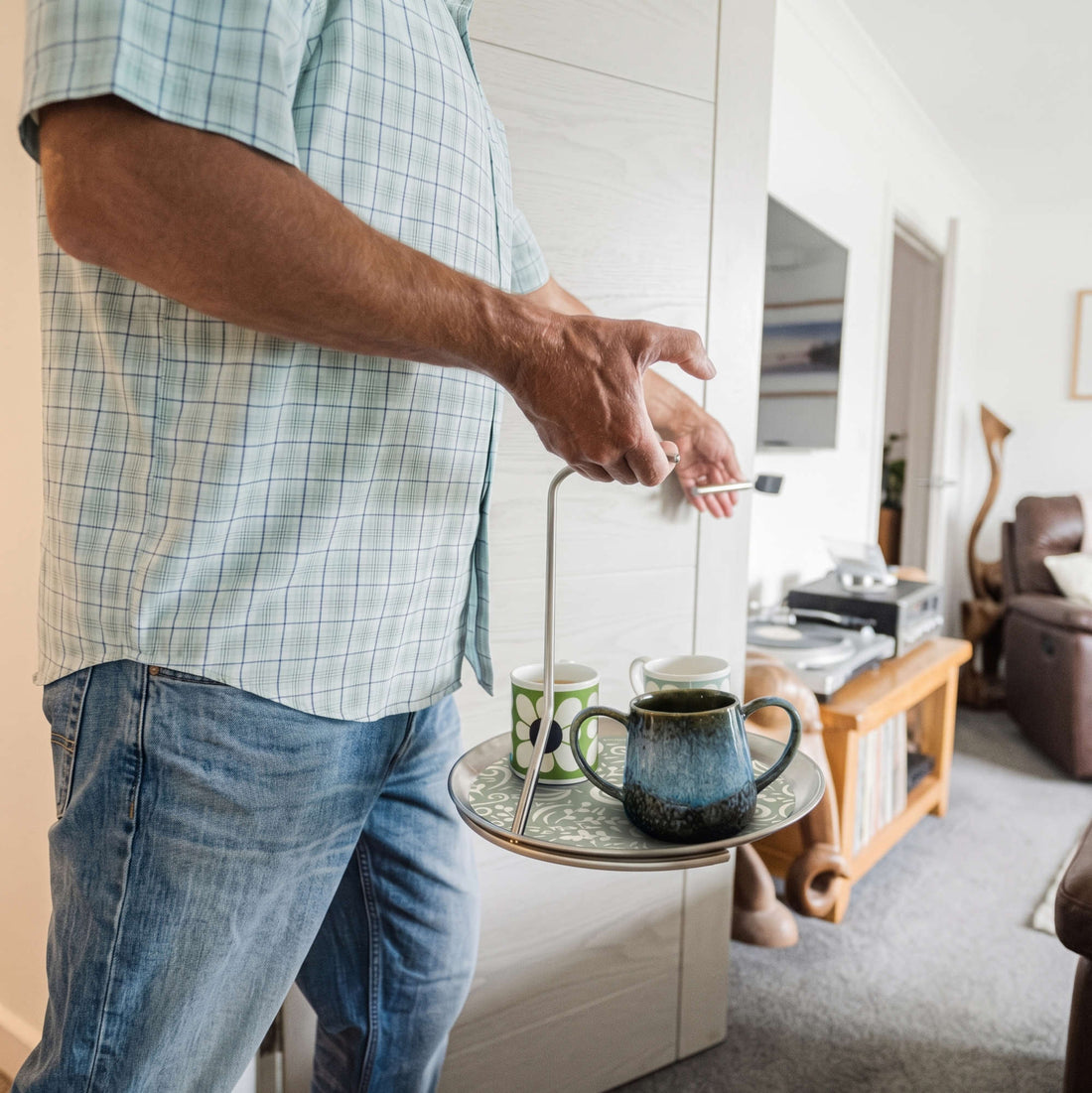 Carrying drinks through a doorway with one hand using the Topple Tray